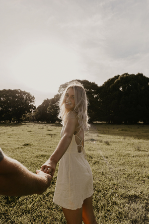 Couple walking in paddock posing for proposal photography at sunset at Gold Coast , Australia