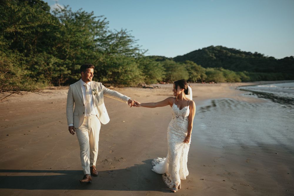 Couple walking along a Guanacaste beach during their wedding session