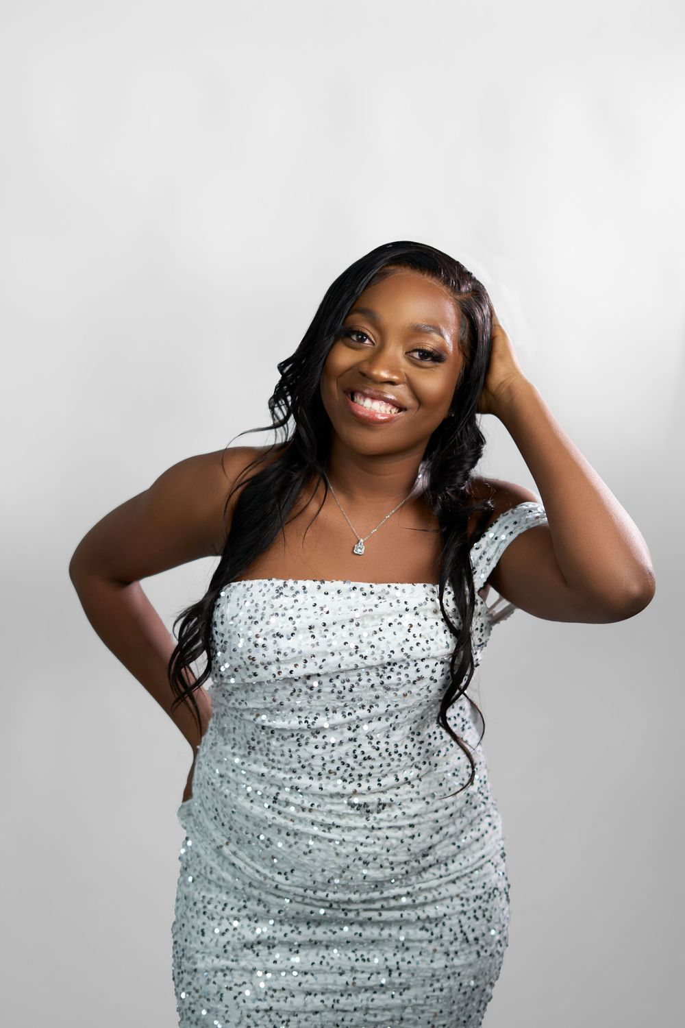 Studio portraits in sparkly silver dress showing joyful, energetic poses.