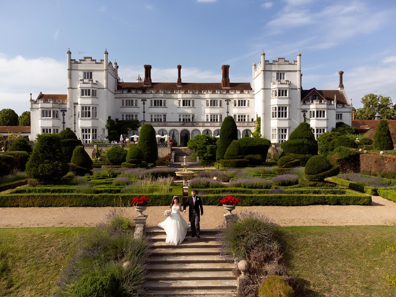 Grand manor house wedding venue with manicured gardens and classical architecture.