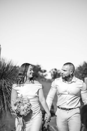 Black and white wedding portraits showcasing tender moments in an outdoor setting.