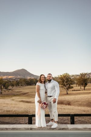 Romantic moment captured on deck with mountain vista in background.