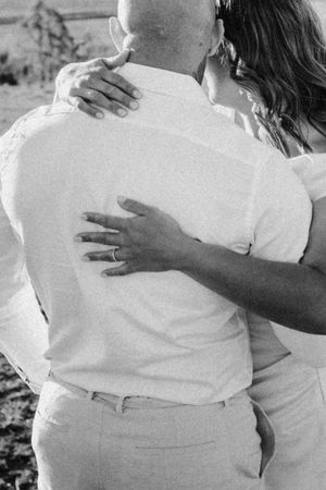 Close-up shots showing tender embraces between family members in white clothing.