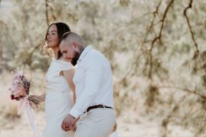Intimate outdoor family photoshoot showing tender moments in white attire.