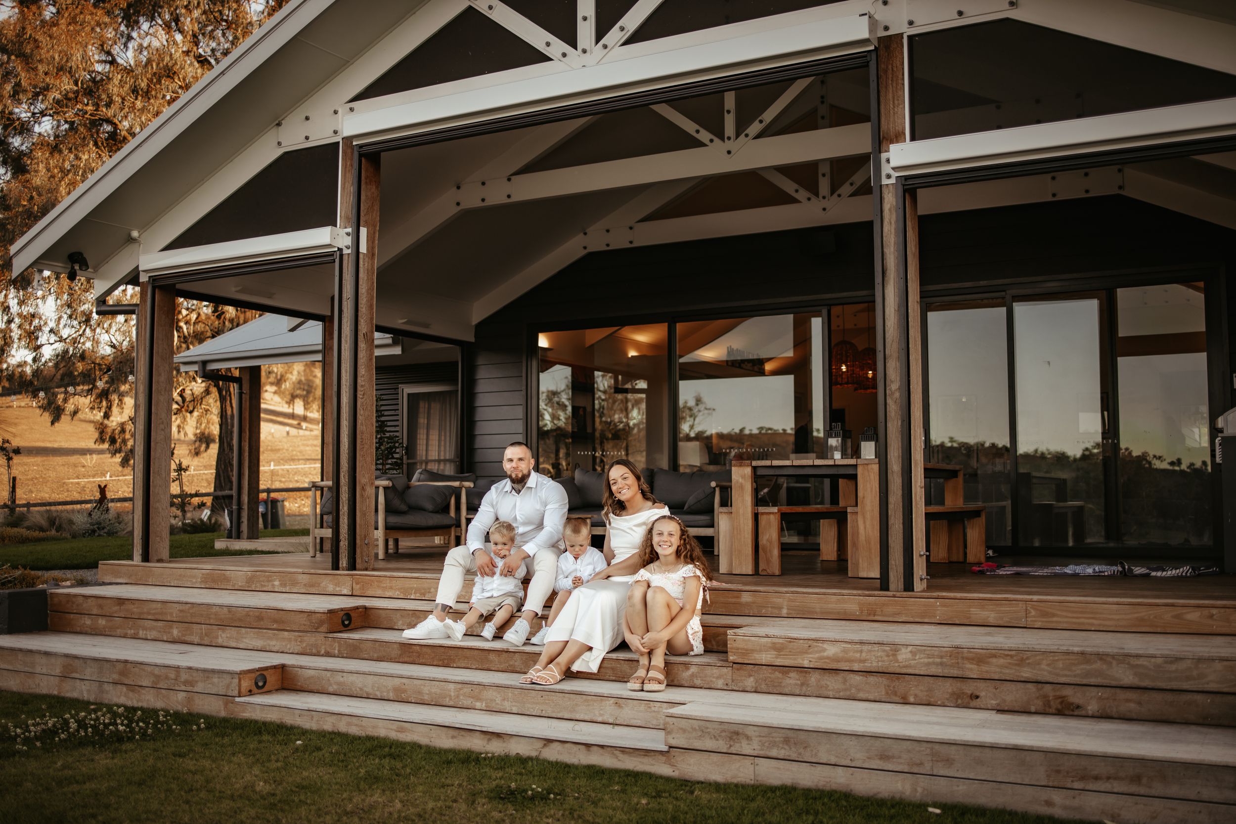 Rustic wooden deck with mountain views at dusk.