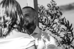 A romantic black and white outdoor couples portrait in a natural setting.