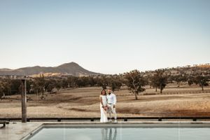 Natural landscape with mountains and swimming pool at sunset.