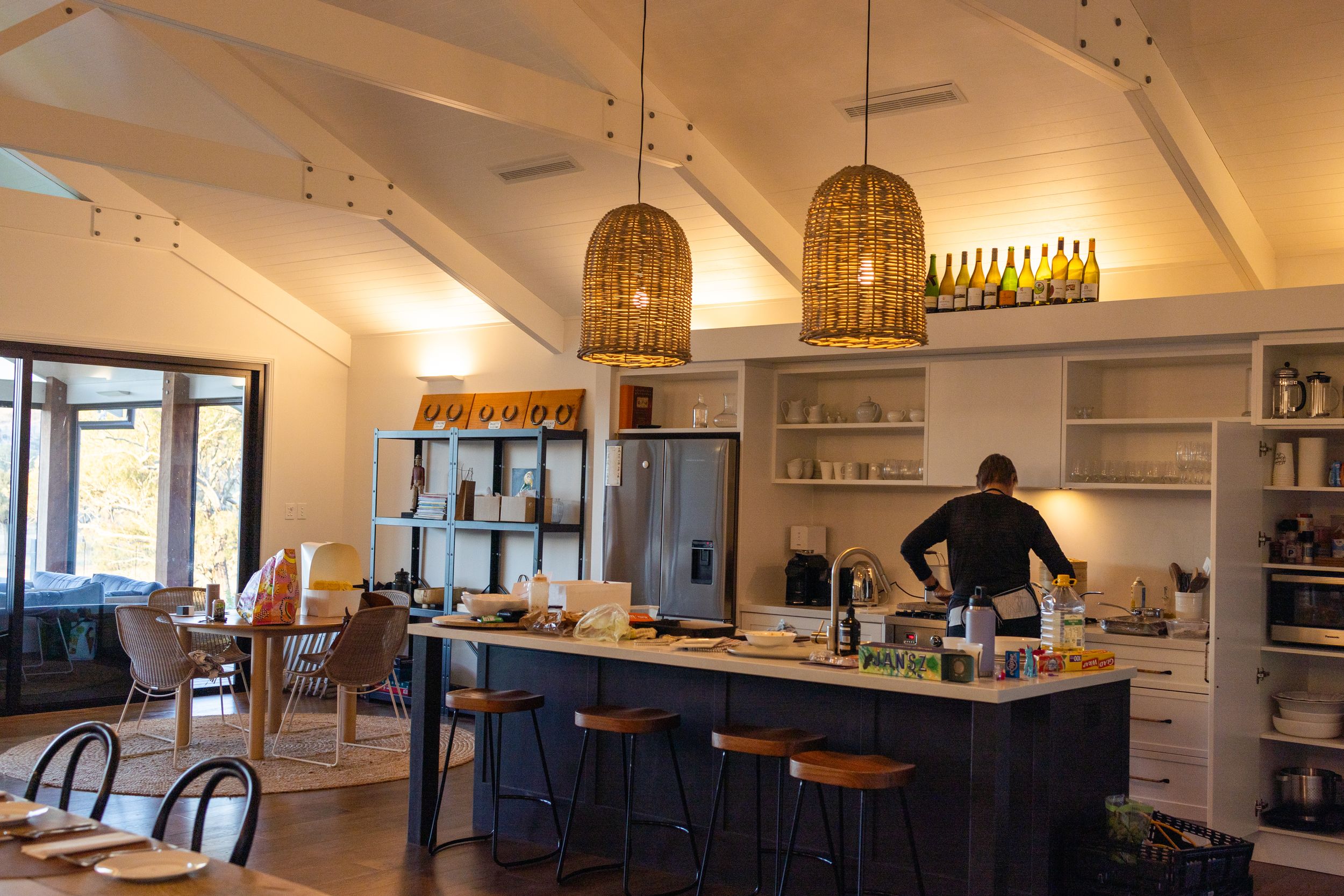 Modern interior space with vaulted ceilings and pendant lighting.