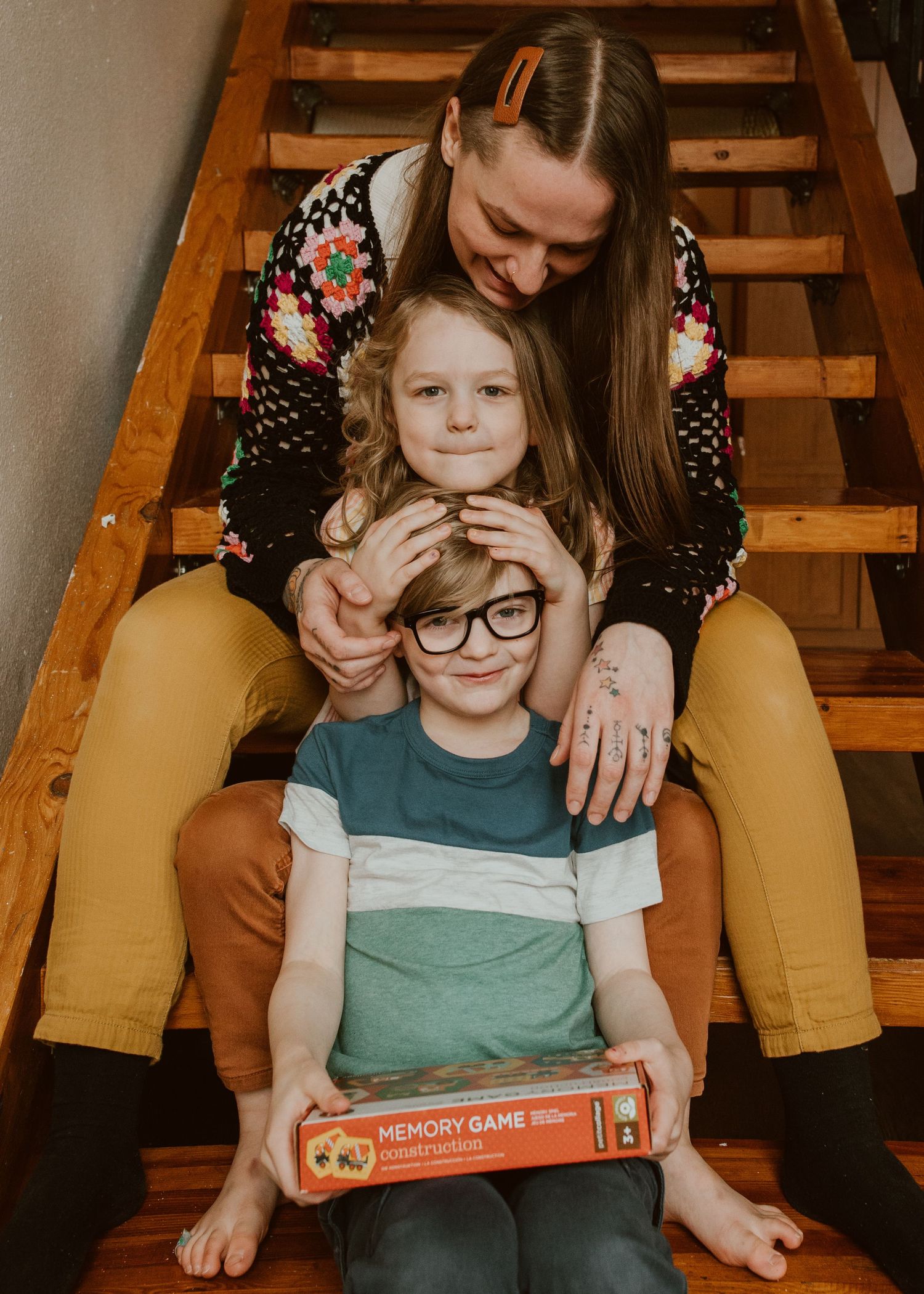 kimberly with two kids on stairs queer family photographer portland oregon