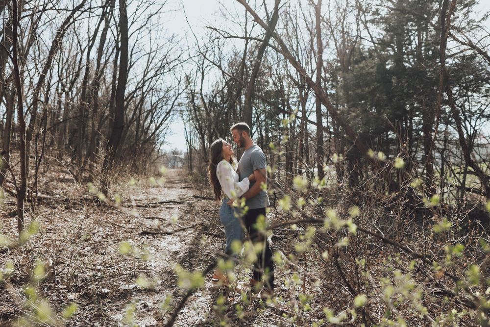 Engagement photo session in a natural wooded setting during winter.