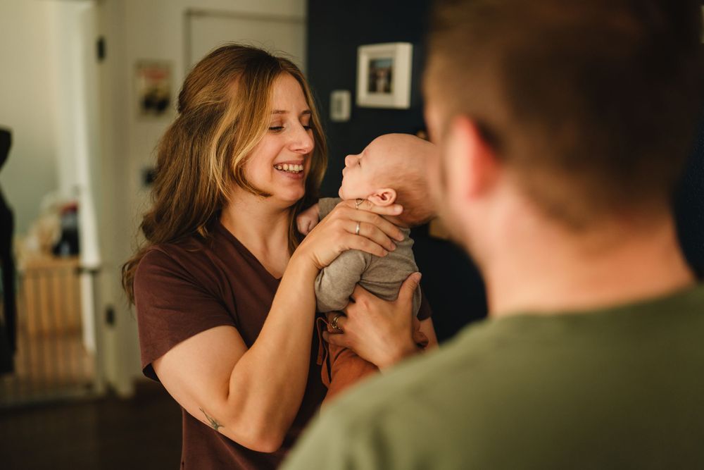 A warm family interaction in a cozy room with natural lighting.
