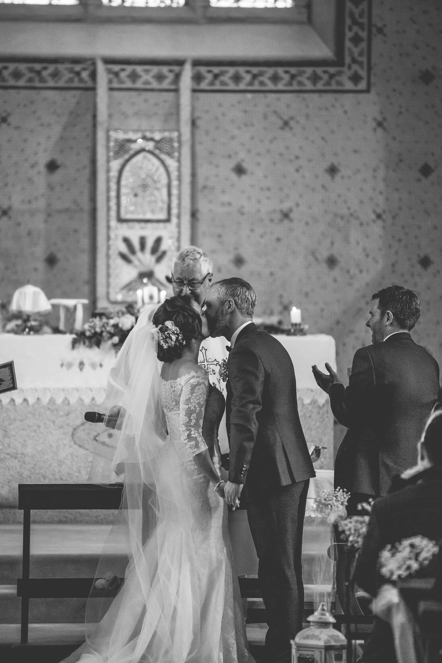 Black and white photo of a traditional church wedding ceremony in progress.