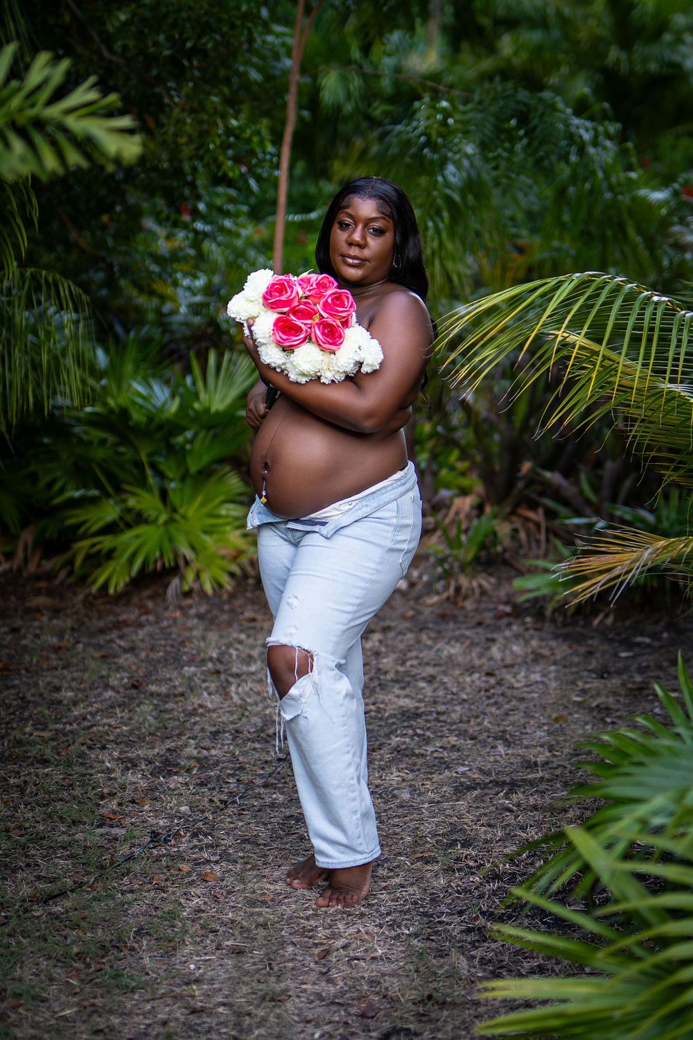 Woman holding flowers in nature — candid lifestyle portrait by Timoy B Photography.
