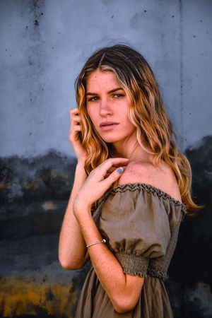 Artistic portrait series against textured blue wall background.