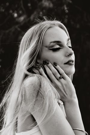 Dramatic black and white portrait series with artistic hand poses.