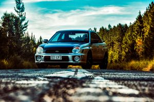 Subaru WRX STI photographed from multiple angles on empty road.