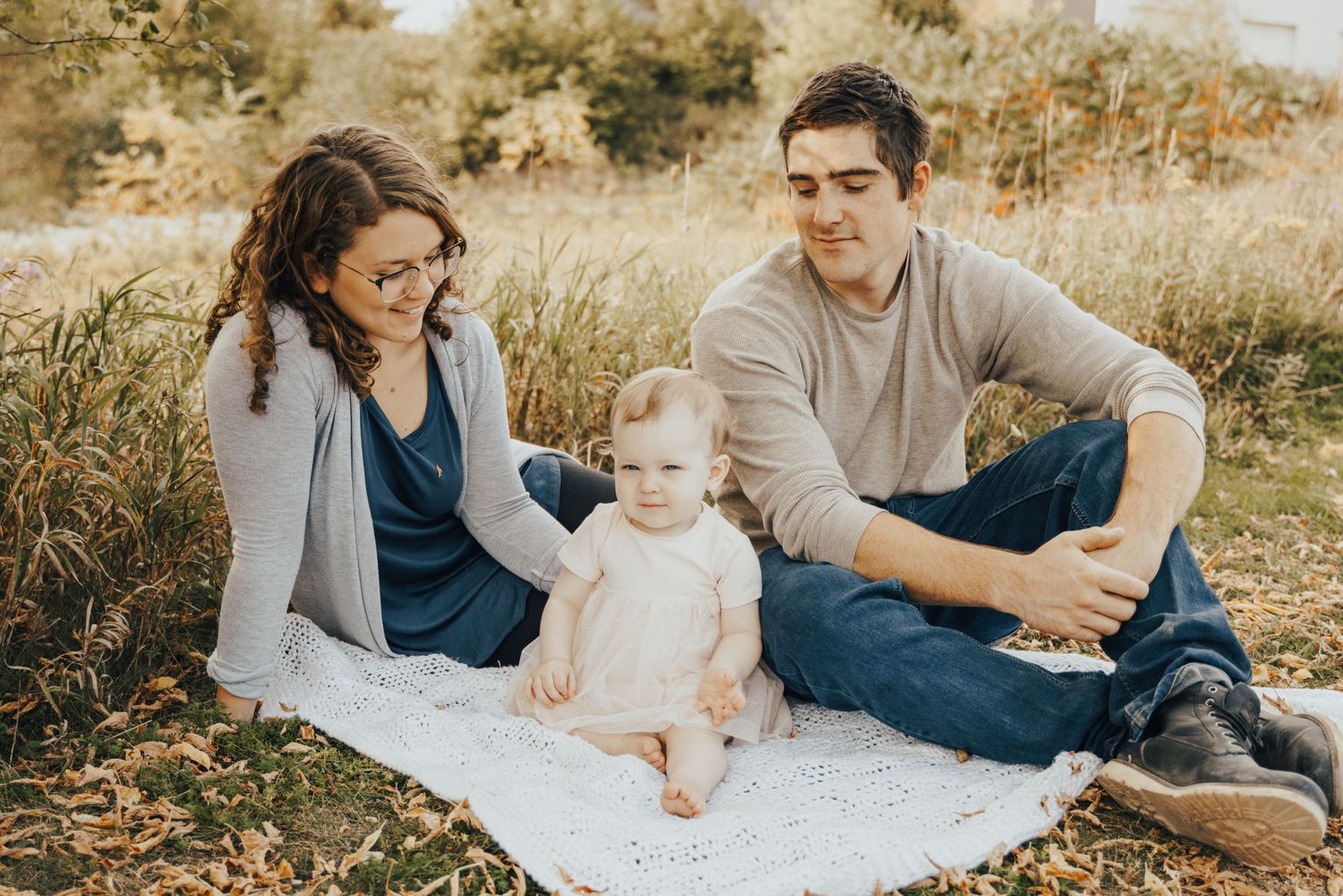 Image of parents sitting on blanket with baby.
