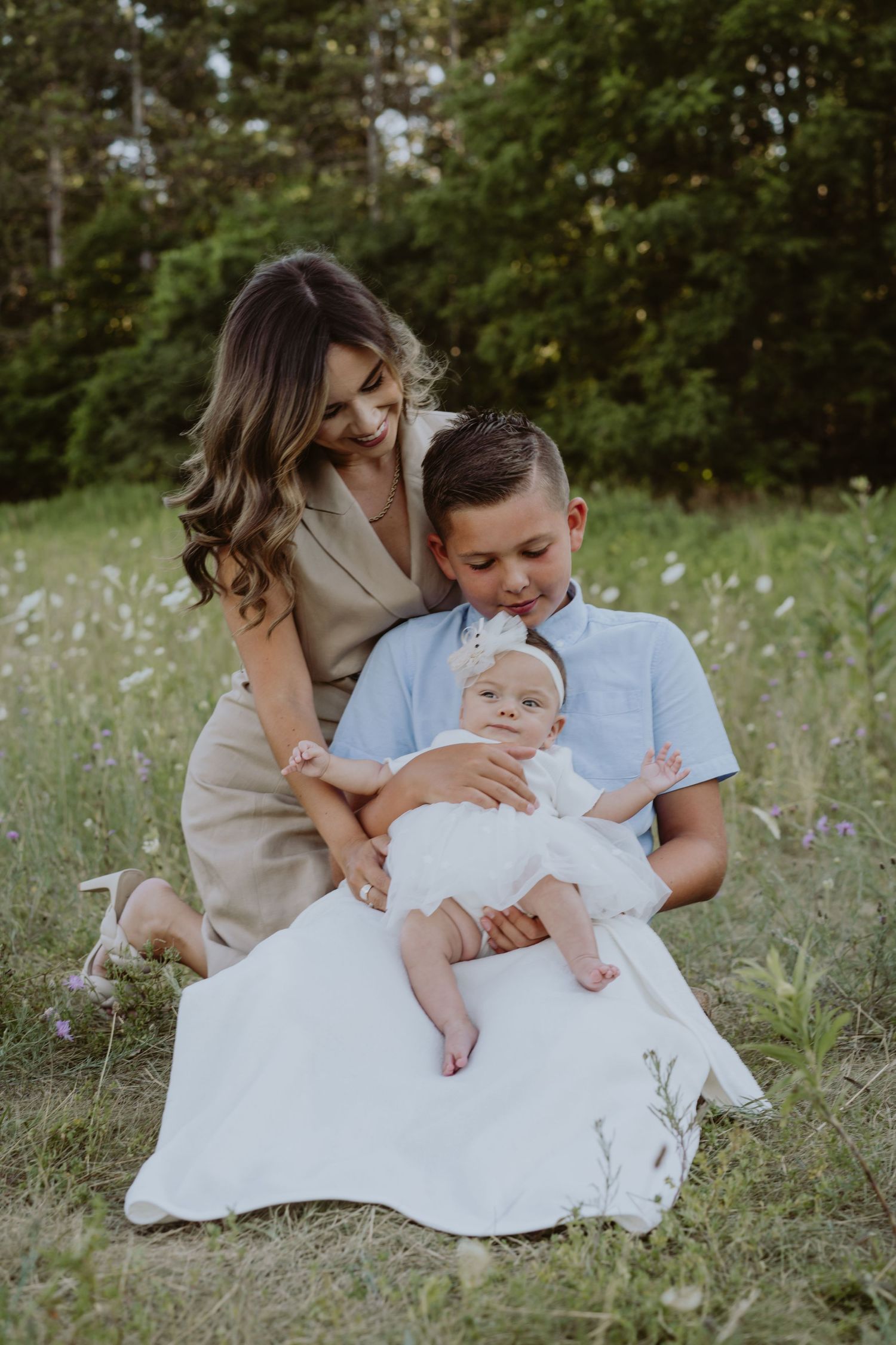 Image of mom and son looking at baby.