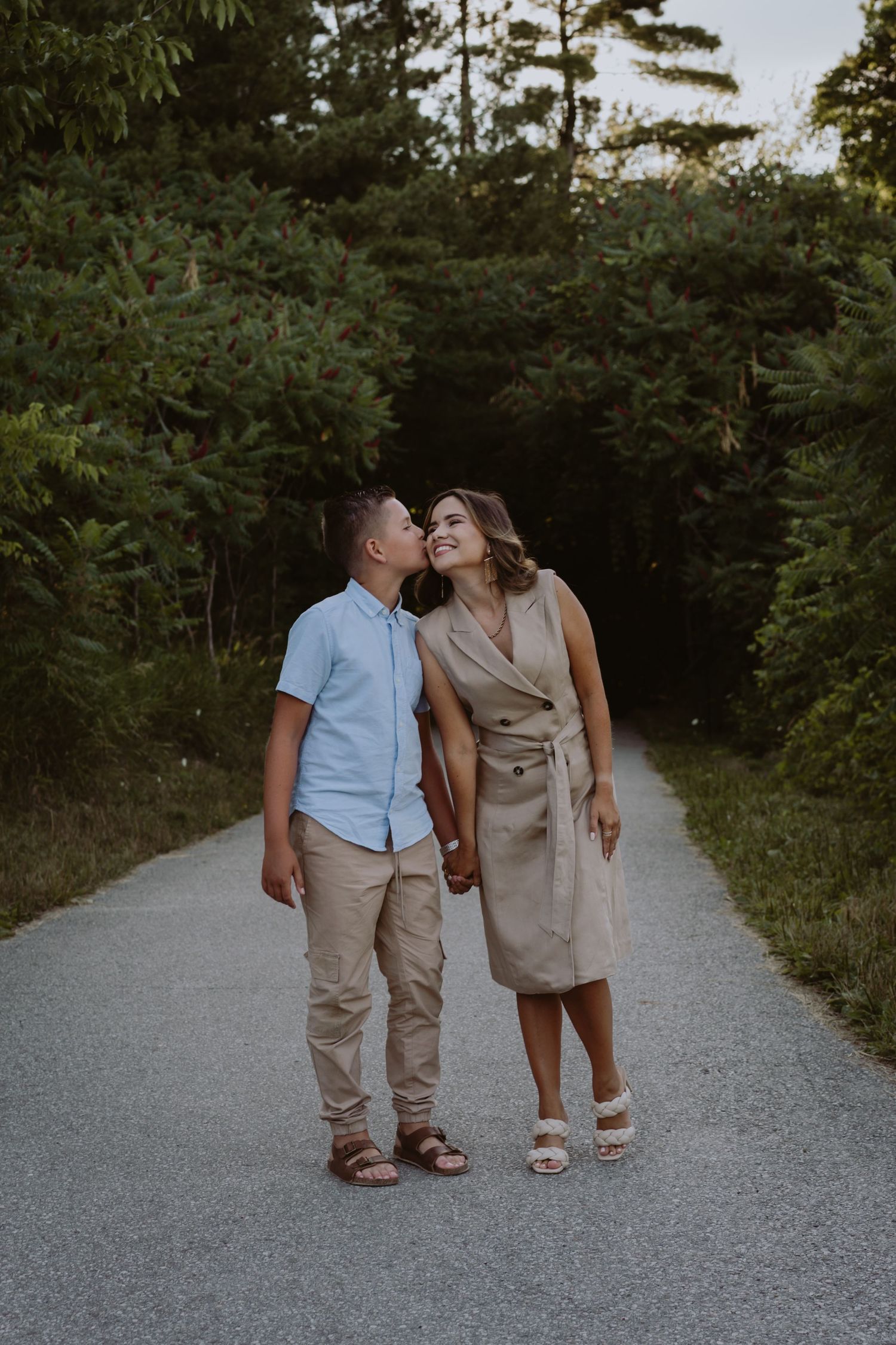 Image of son kissing mom on cheek.