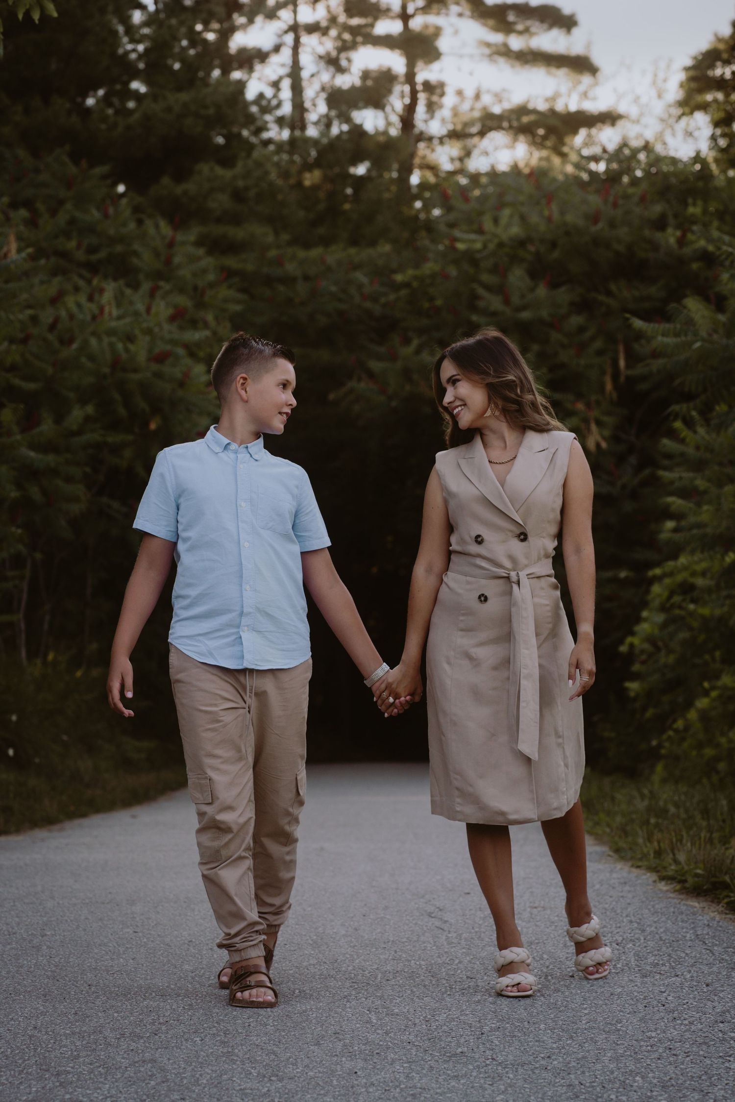 Image of mom and son holding hands down a path.
