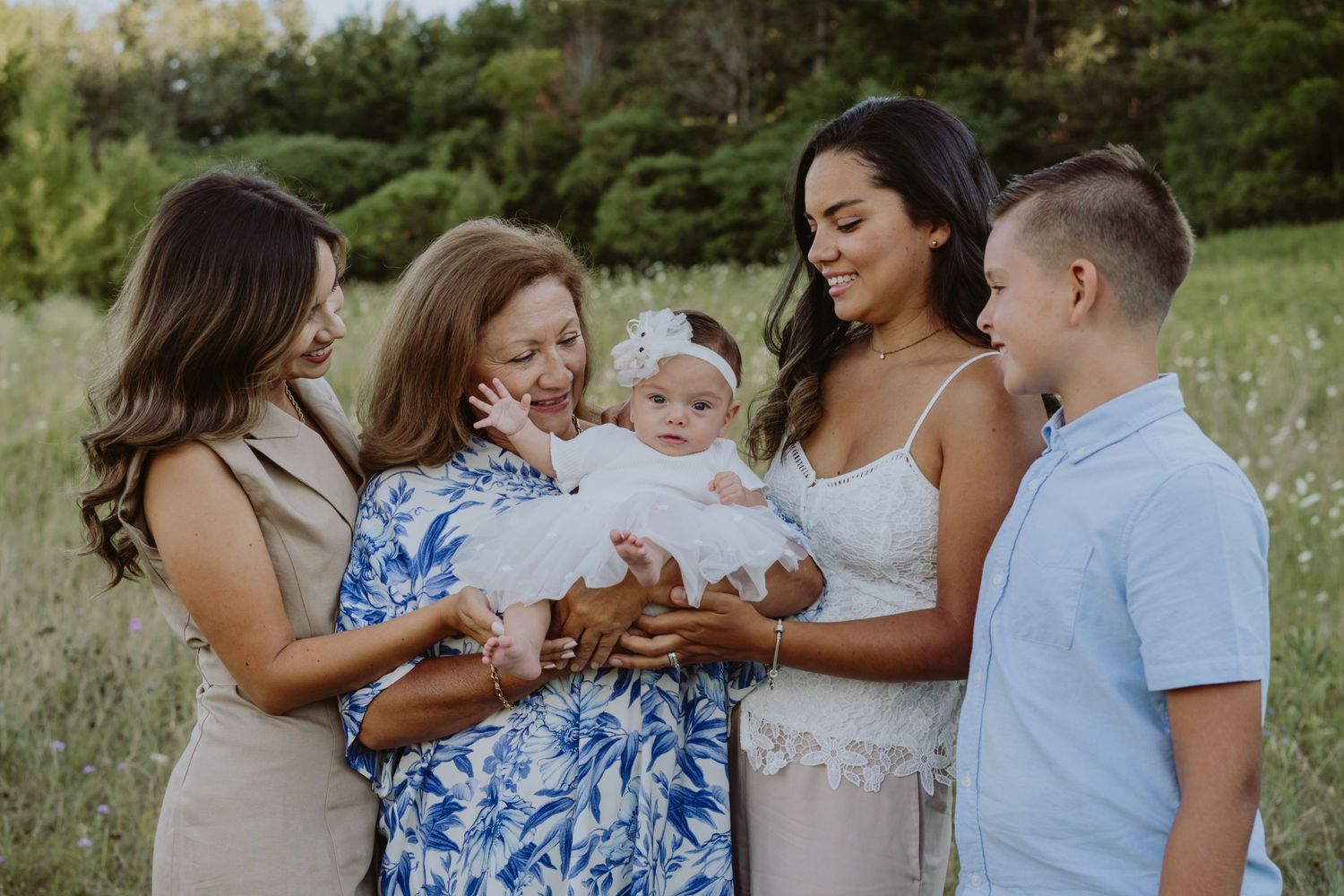 Image of a family all looking at baby.