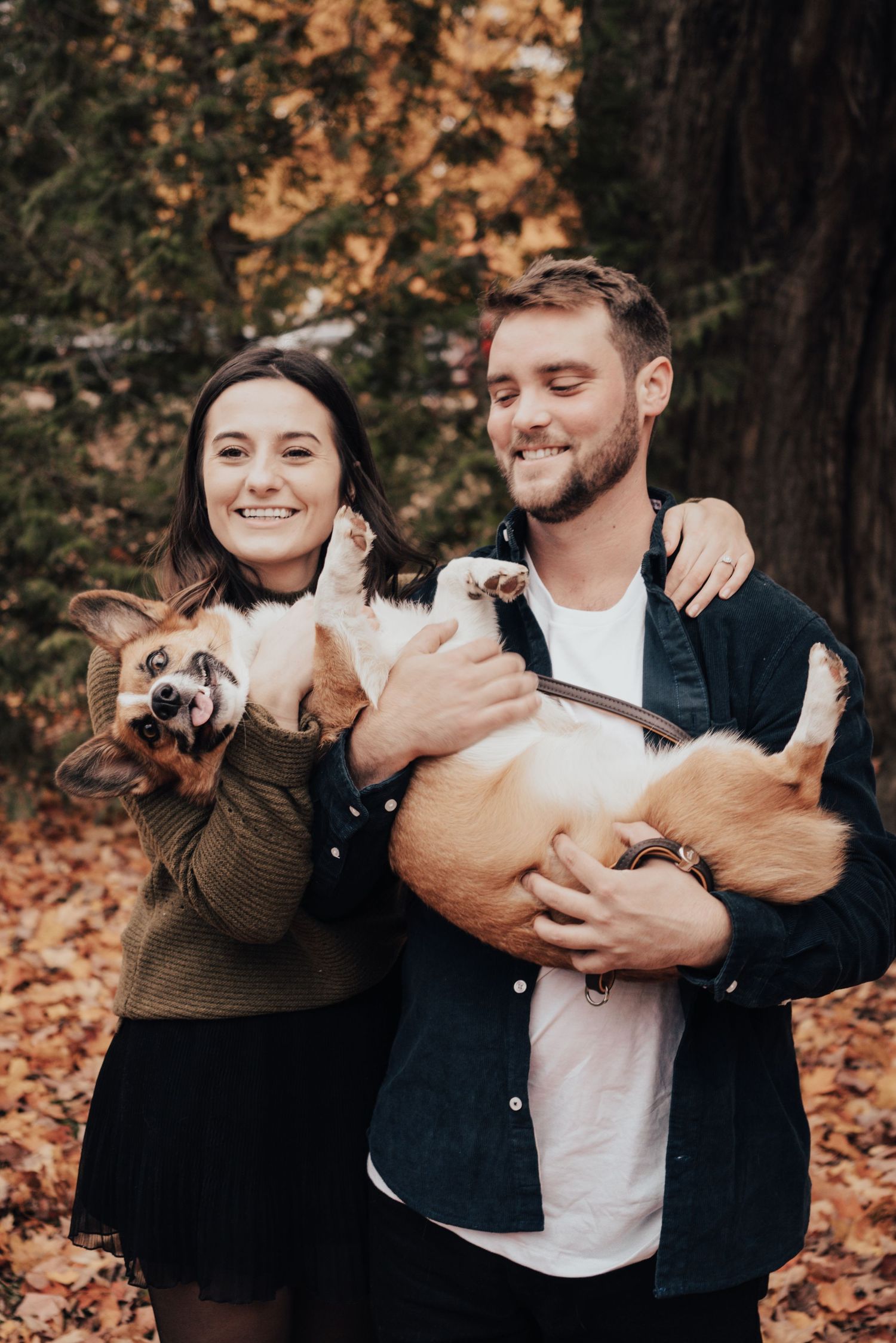 Image of couple holding their dog.