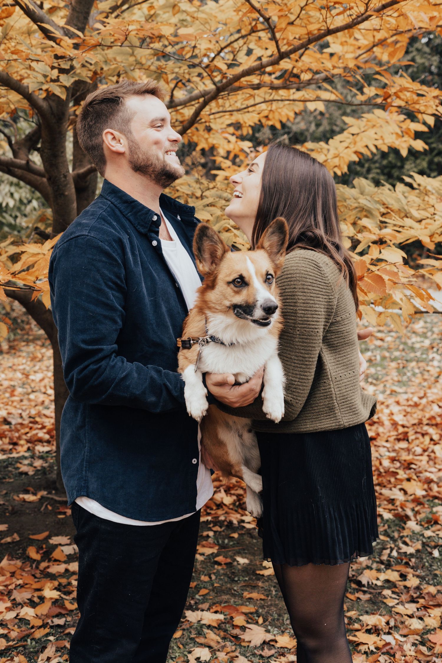 Image of couple holding their dog.