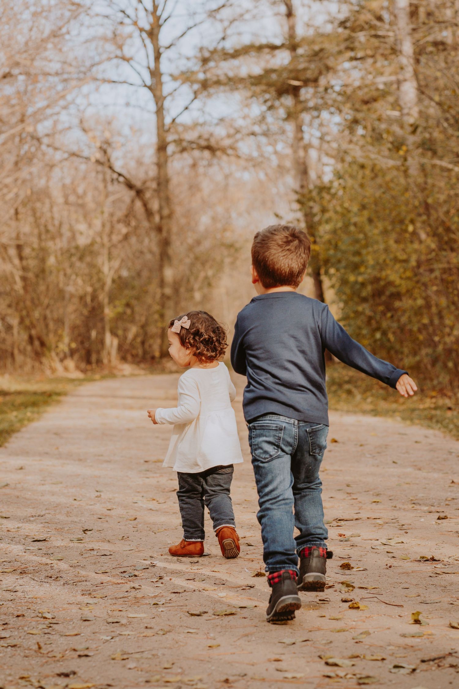 Image of children running away from camera down a path.