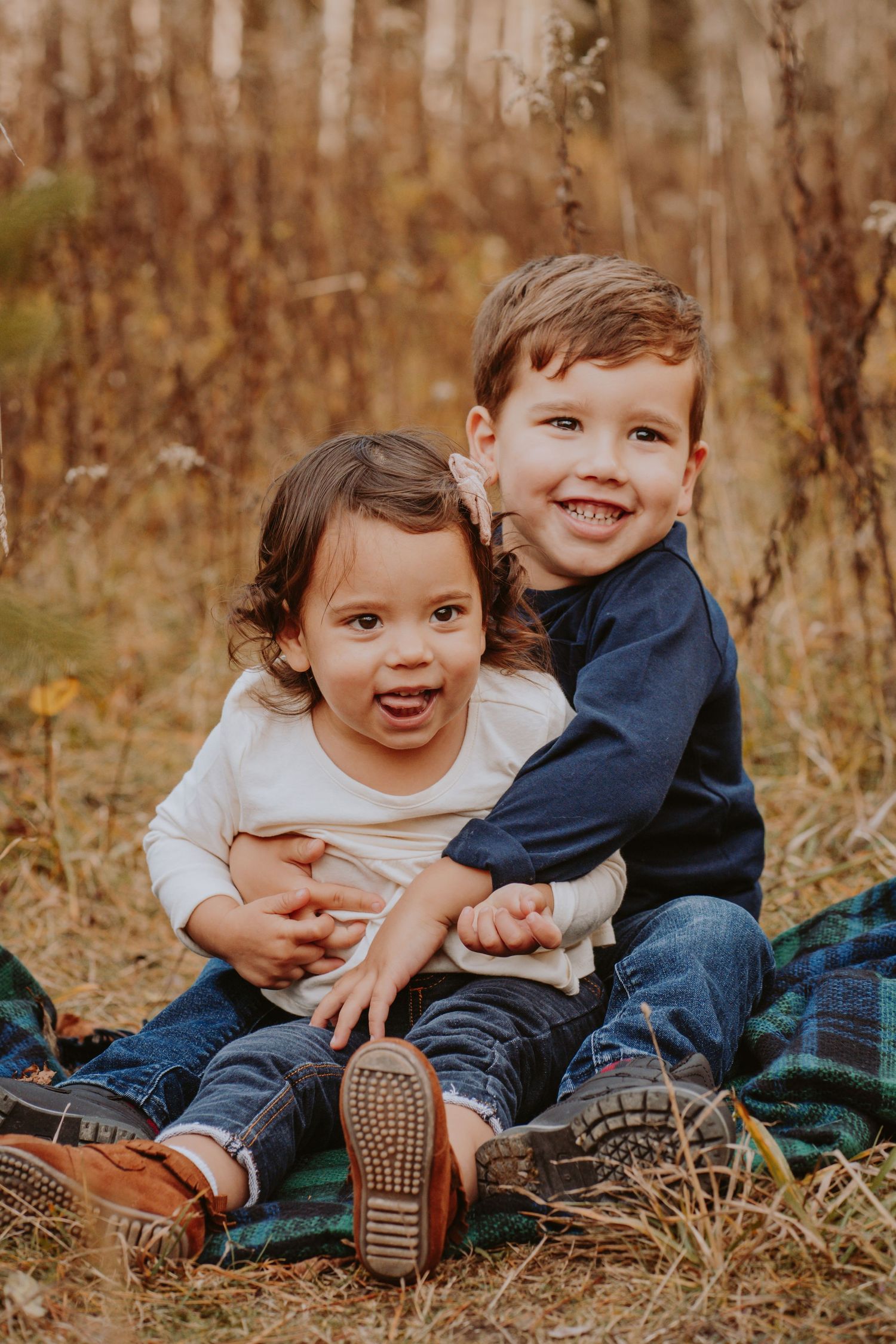 Image of young children sitting in leaves.