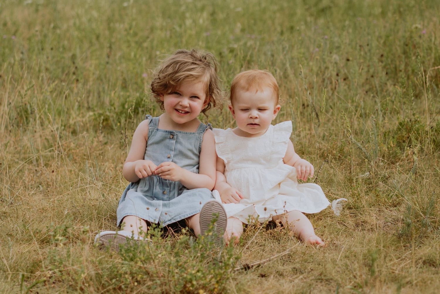 Image of young girls sitting in field.