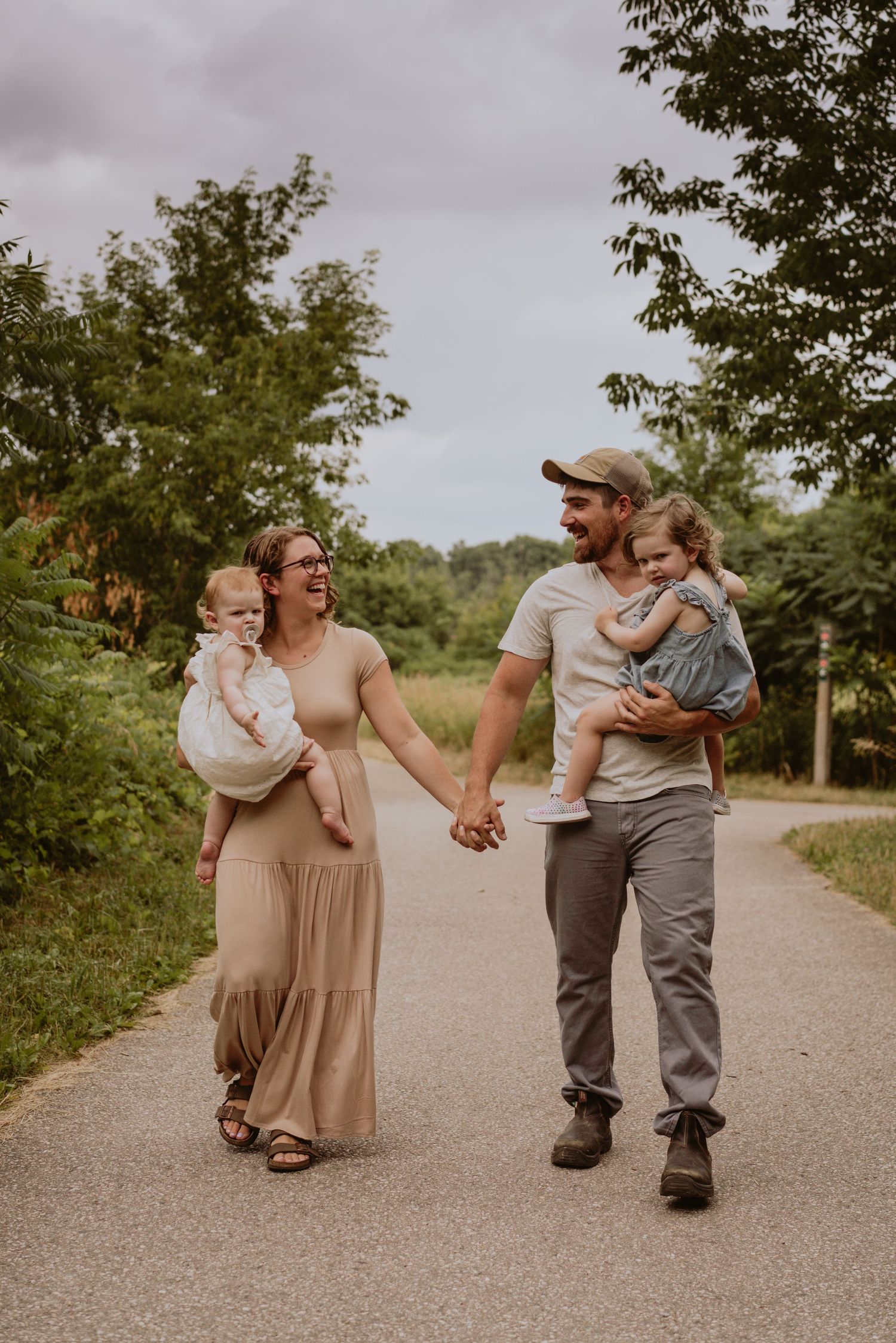 Image of family walking down path smiling at eachother.