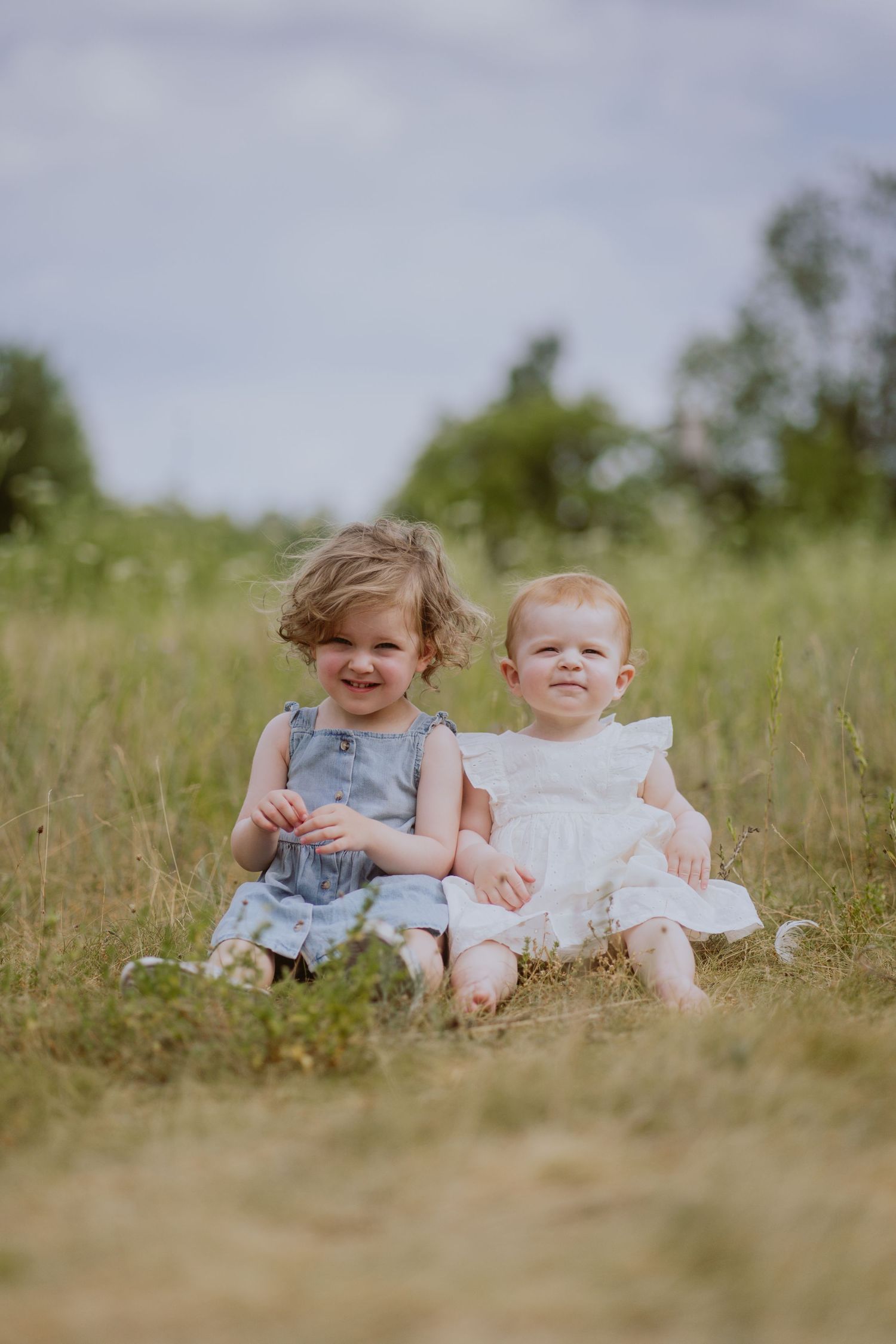 Image of young girls sitting in field.