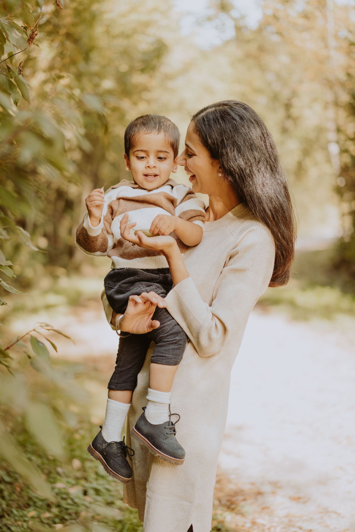 Image of mom holding son and smiling.