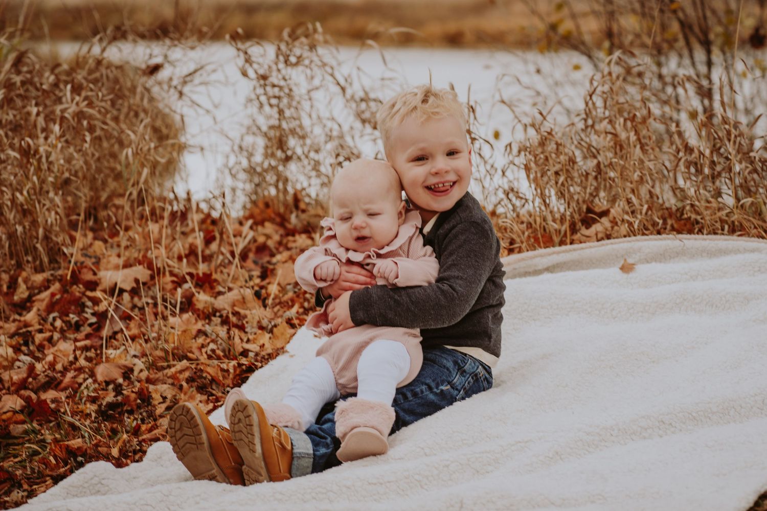 Image of young boy and girl in front of water.