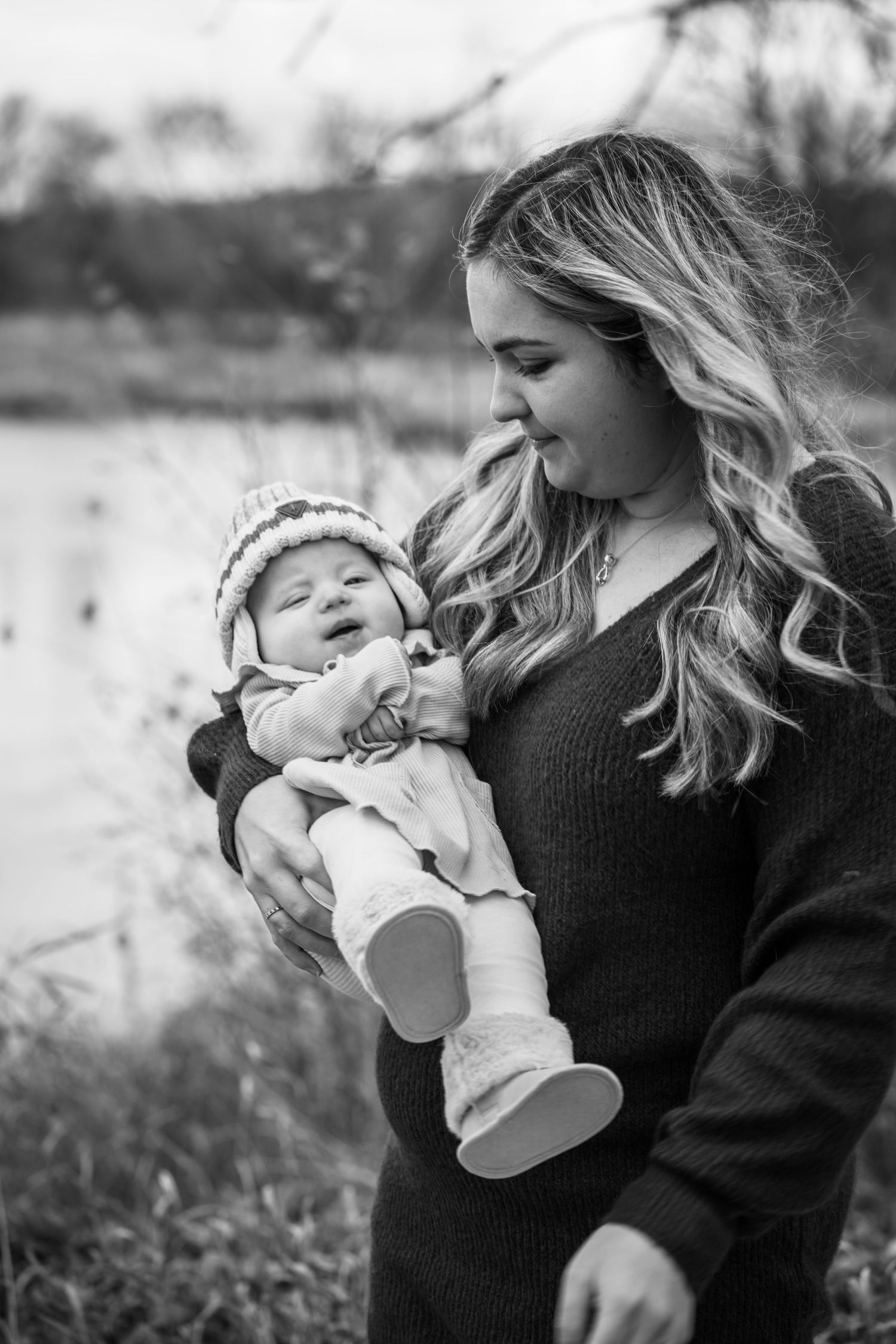 Image of mom and baby in front of water.