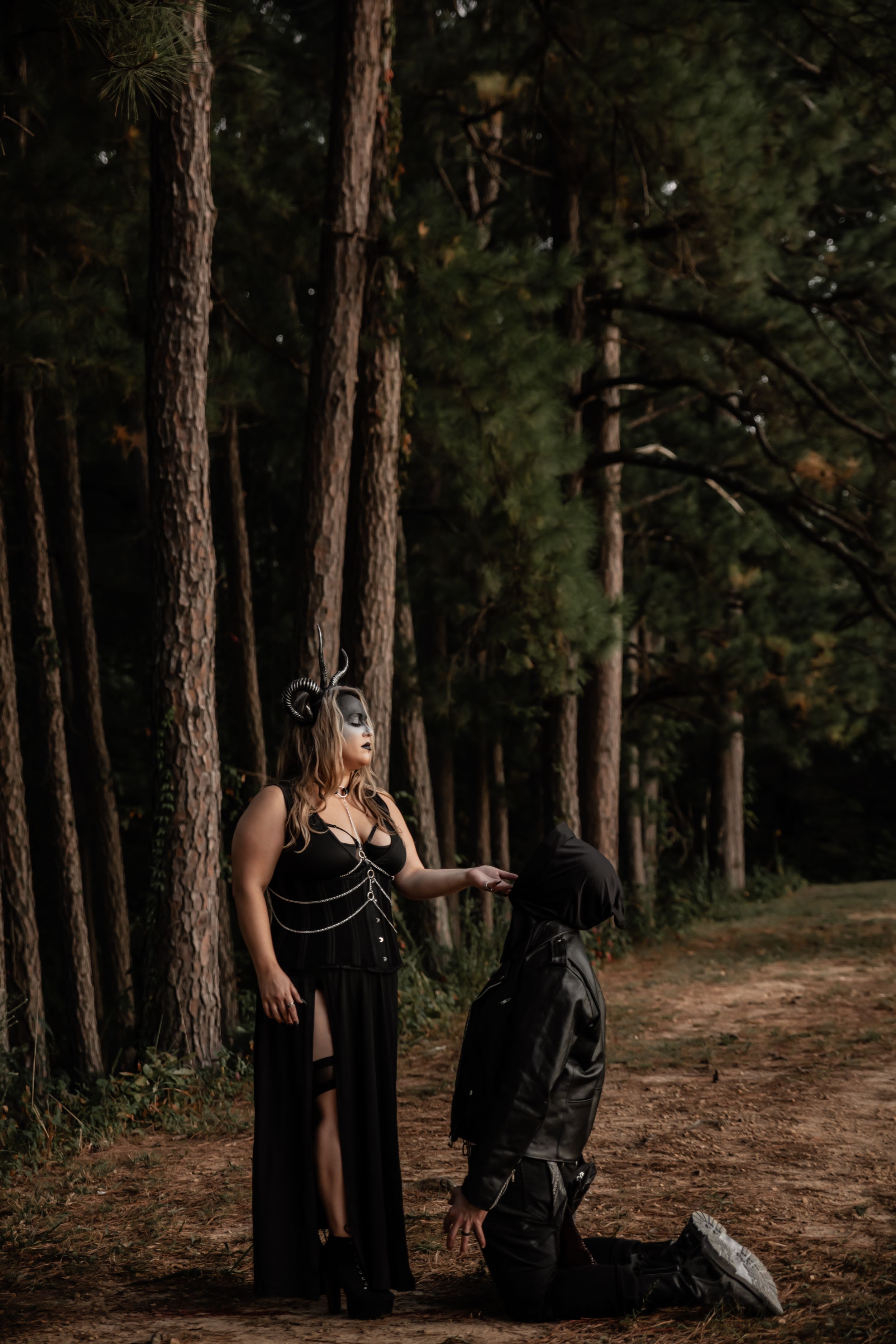 Atmospheric forest photography with masked subjects creating dramatic poses between trees.