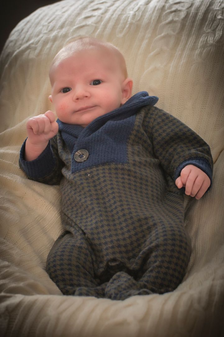 Baby in a jumper looking at camera