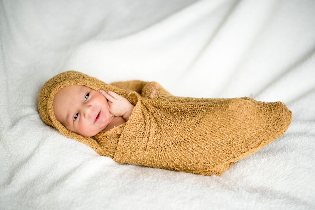 Swaddled smiling newborn