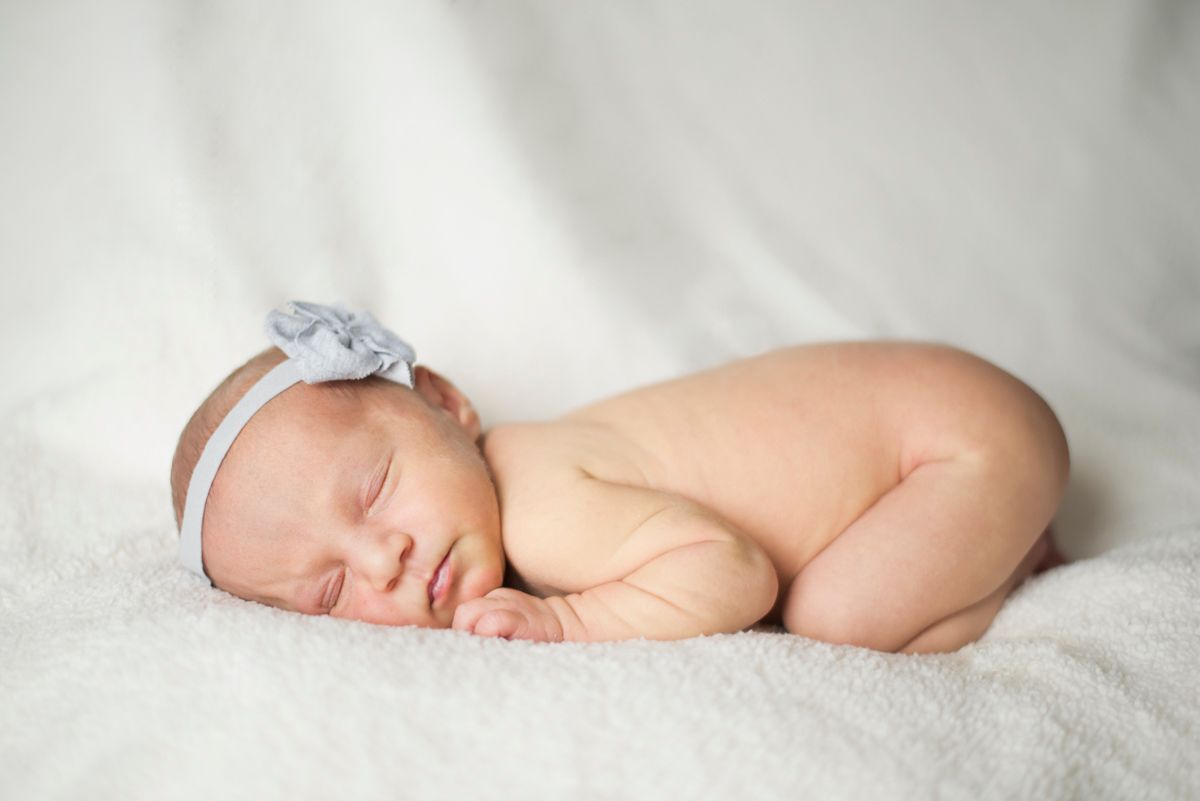 Sleeping newborn with bow