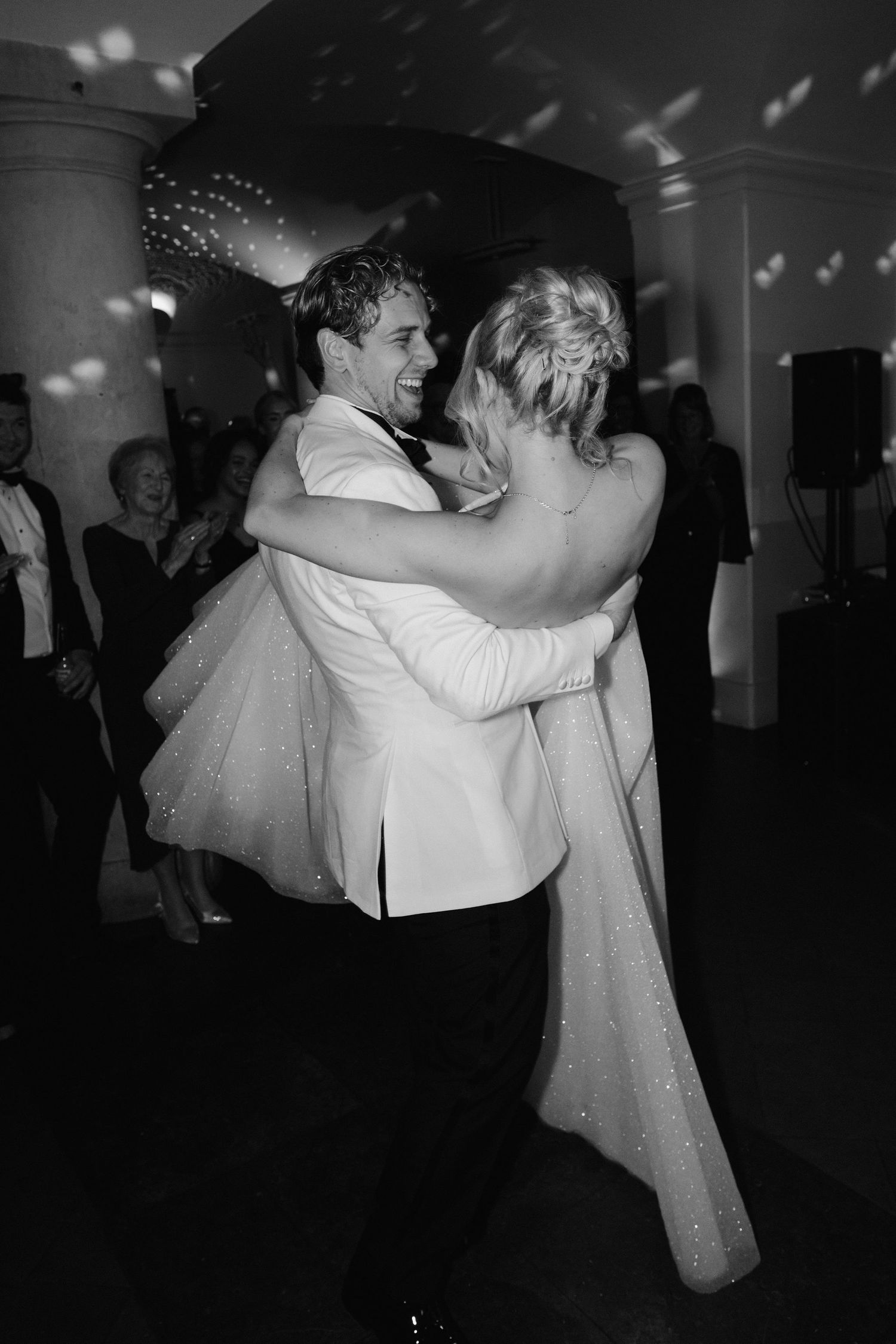 groom lifting bride during the first dance in the vaults at the ashmolean museum in Oxford