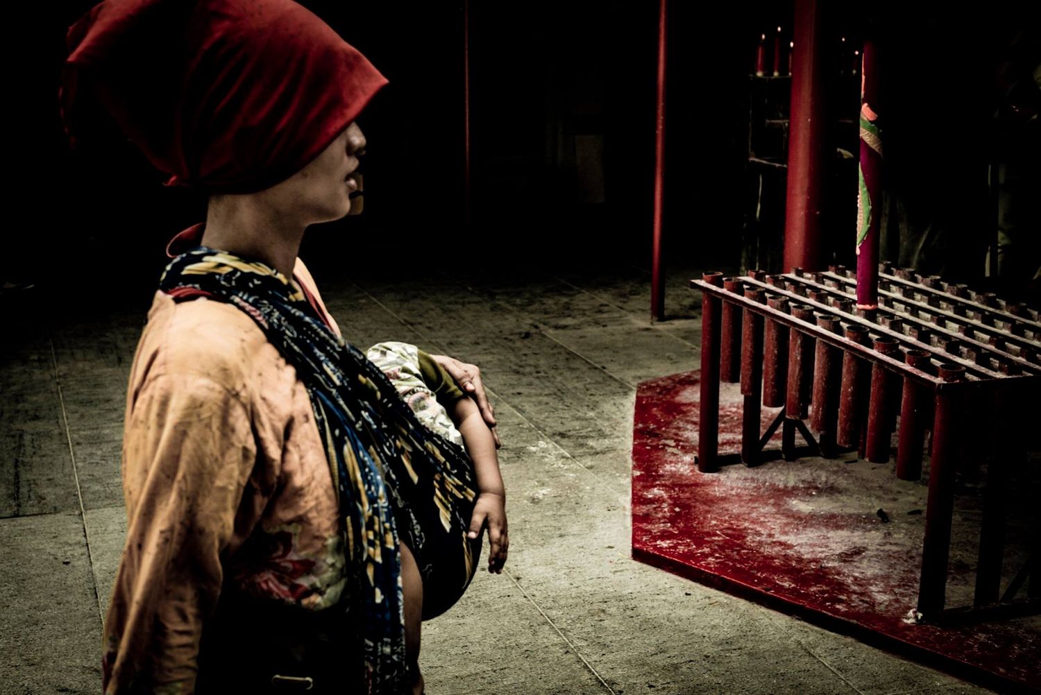 Woman walking with small child at buddhist temple in Gloodok district of Jakarta Indonesia