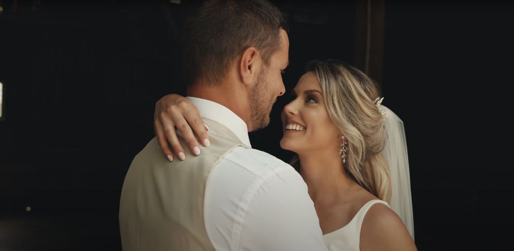 An intimate moment between newlyweds in natural light.