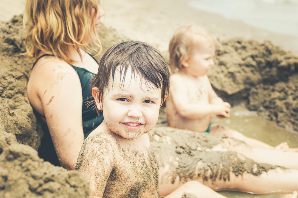 Children playing with the sand at beach photo shoot sessions marbella