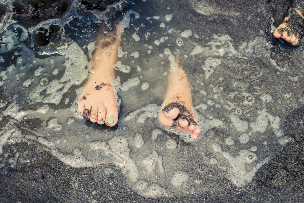 Children feet in the muddy sand at family photography sessions Fuengirola