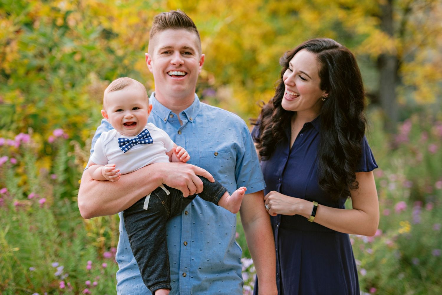 Smiling baby and parents share a happy moment in Julia Davis Park