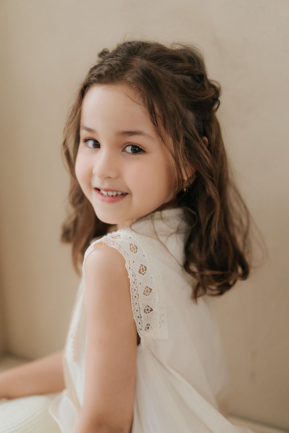 Portrait series in soft beige tones featuring delicate lace clothing details.