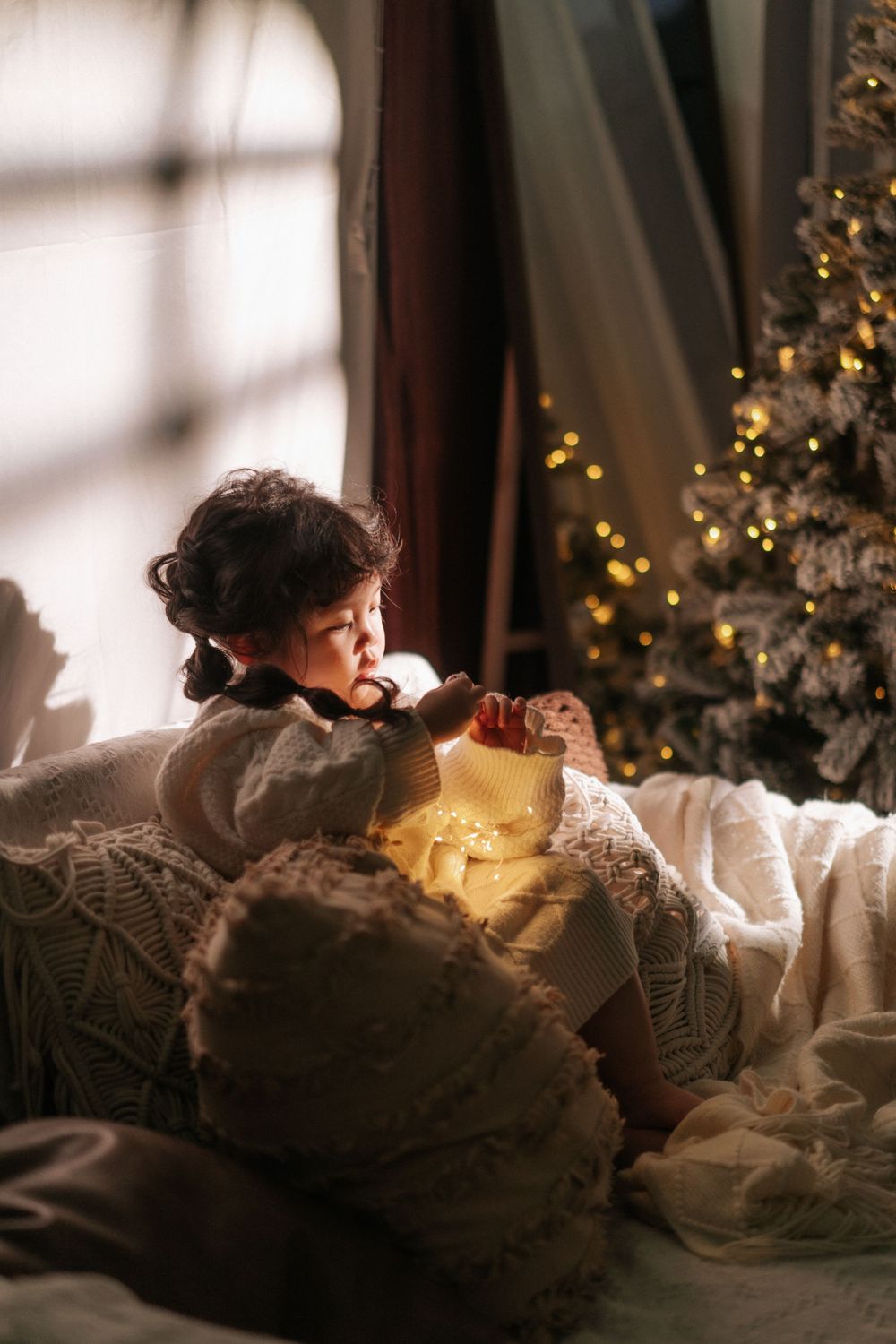 Cozy indoor scene with soft lighting and decorative holiday elements.
