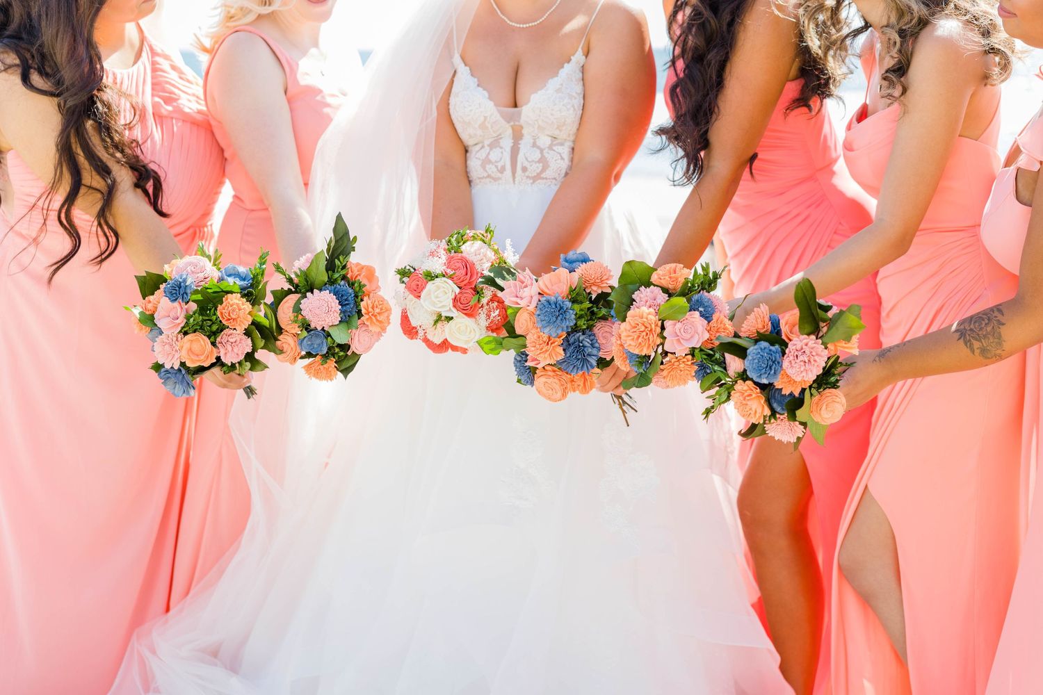 Bride and bridesmaids holding their flower bouquets in Del Mar