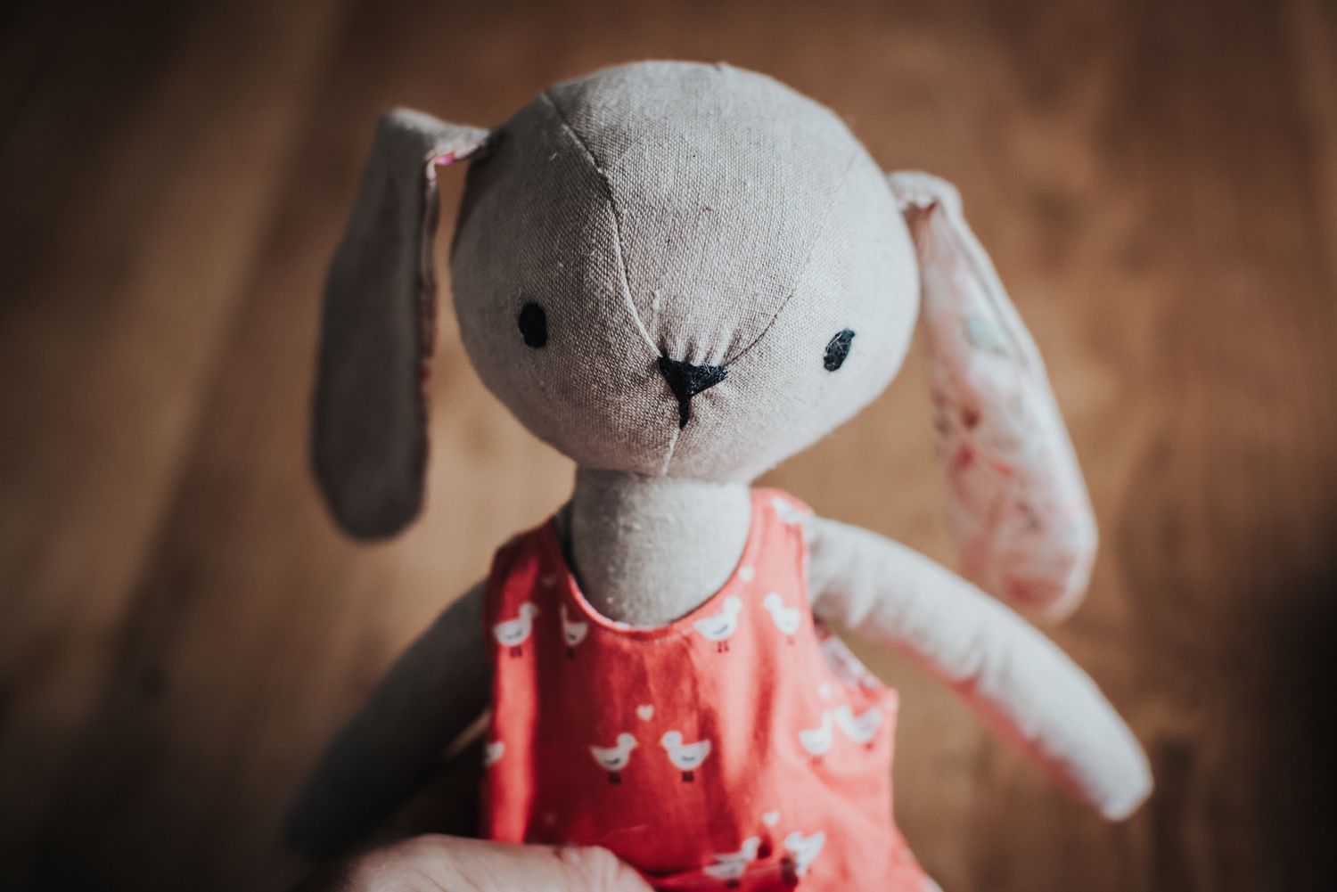 Custom memory toy bunny made with linen and wearing clothes repurposed from a child's clothing.
