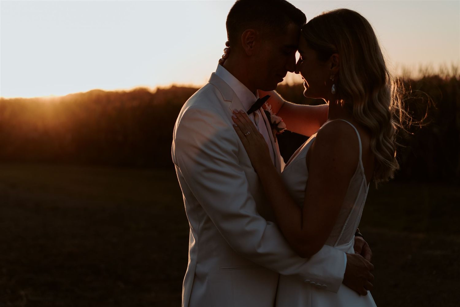 silhouette of bride and groom during sunset